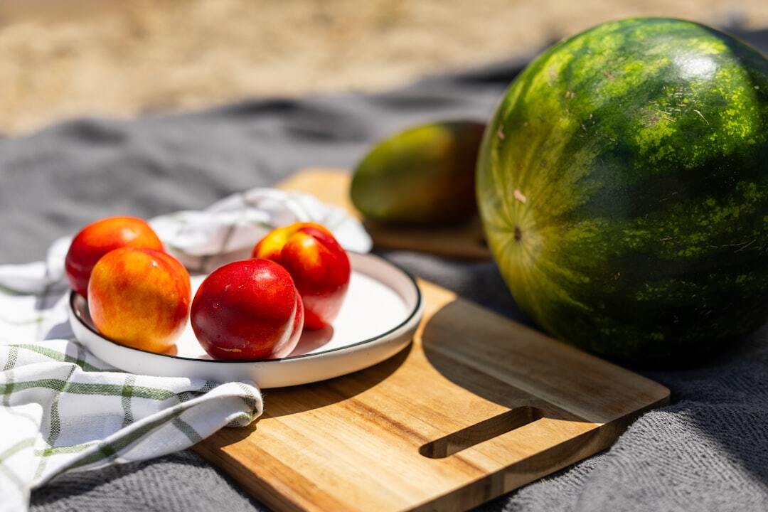 Fresh watermelon and nectarines on a picnic blanket