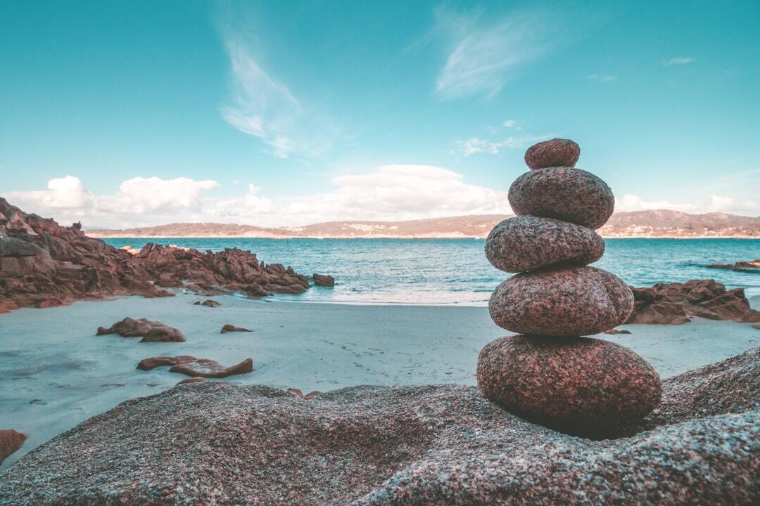 Grey rocks on seashore during daytime