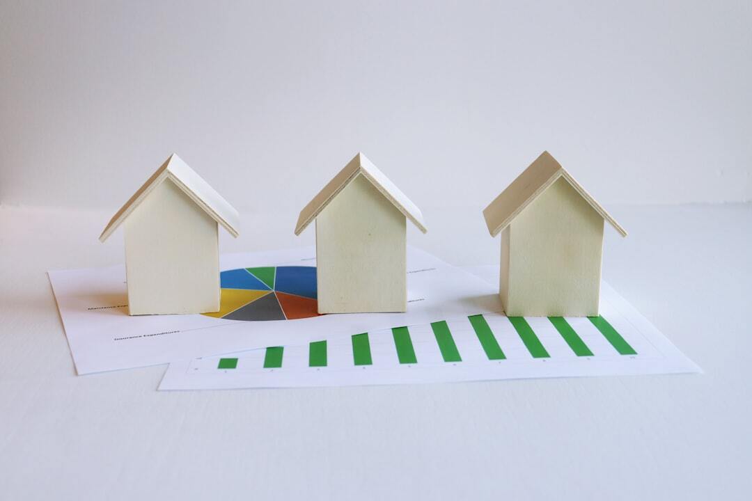 Three small houses sitting on top of a piece of paper